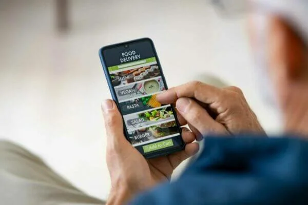 mobile app development Man using mobile app to order delivery food