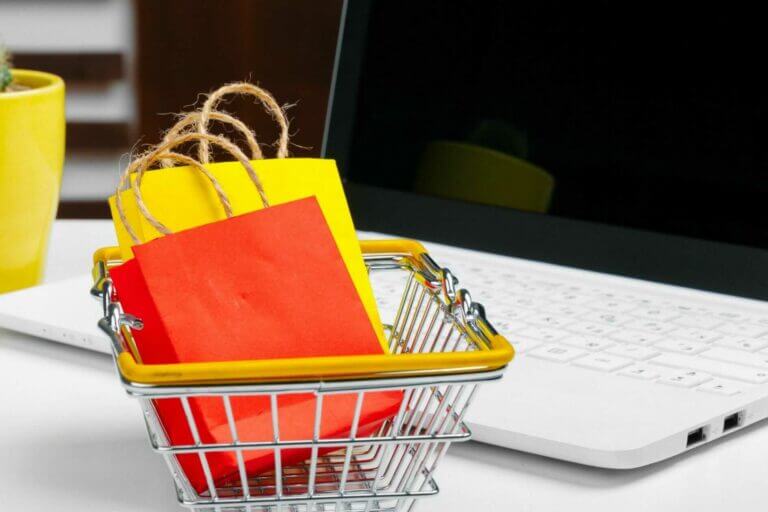 customised checkout process Online shopping concept. Shopping cart, laptop on the desk