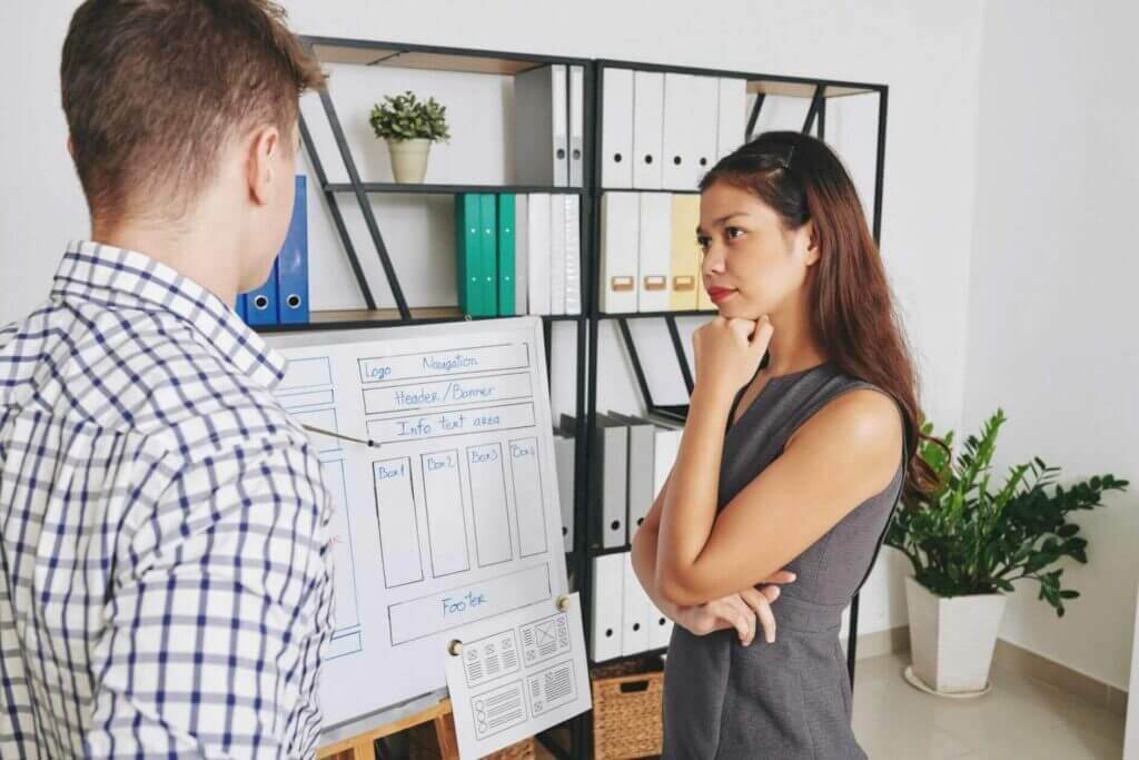 Our ecommerce website design company in Vietnam discussion FAQs Business woman listening to ui designer