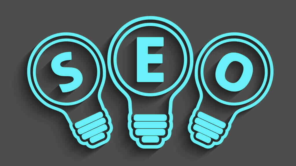 professional seo services wrote in blue in lightbulbs on grey background.