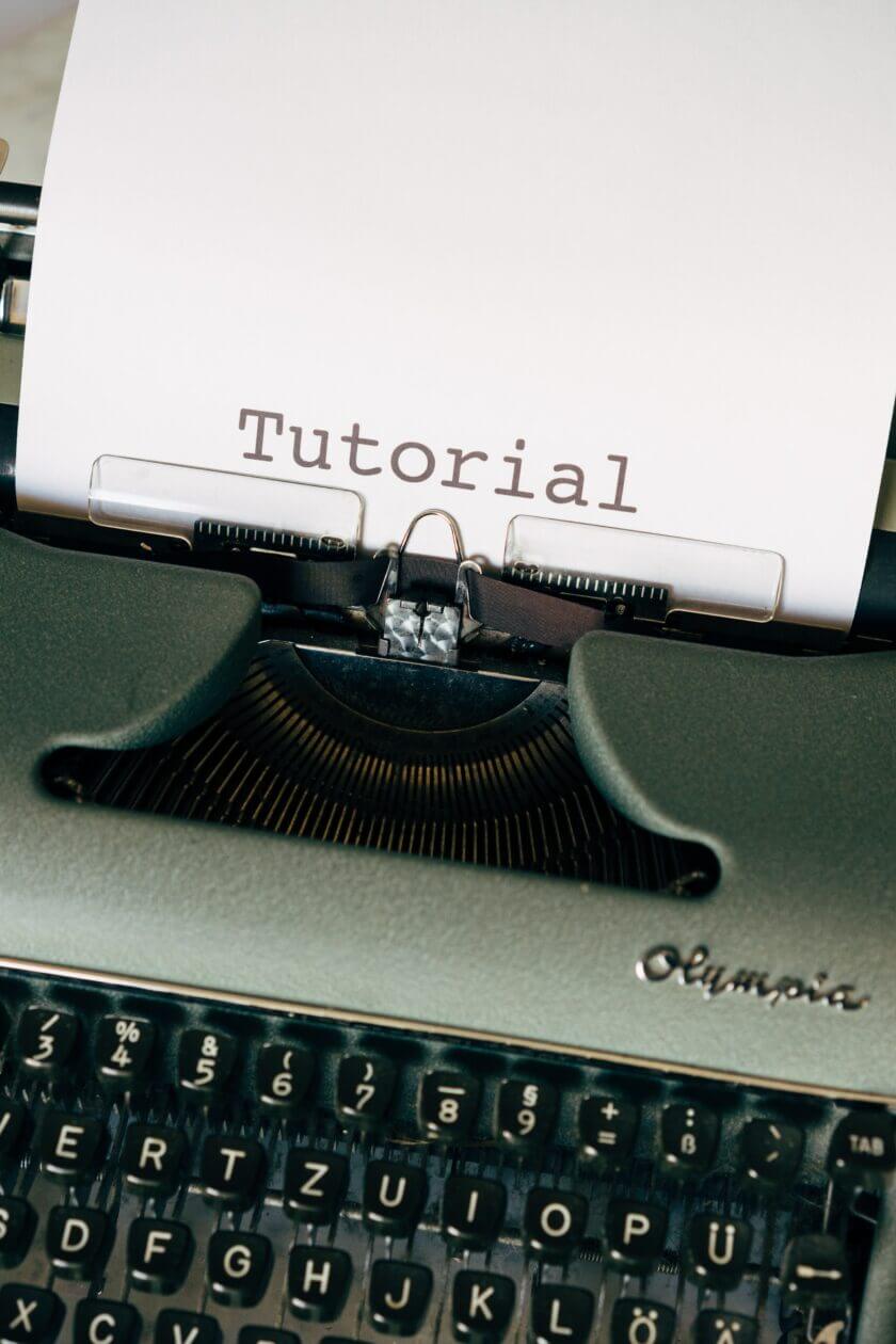 Content marketing services in vietnam using a typewriter and a paperholder saying tutorial
