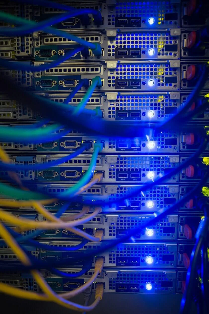 Interior of server with wires blue close up in data center for website hosting at our web design agency in Saigon.