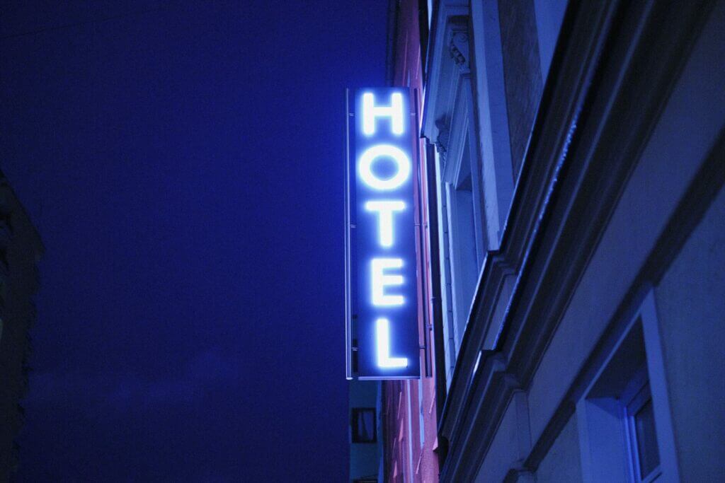 hotel website design company in Vietnam showing a neon sign with the word hotel lit in white.