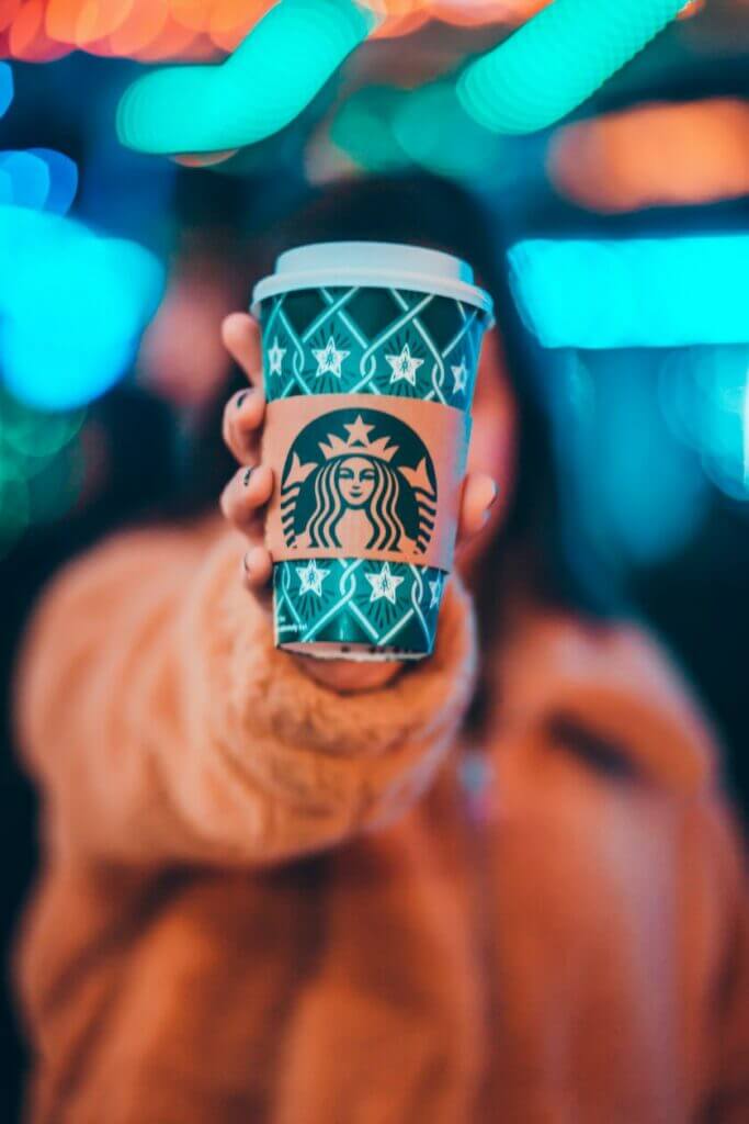 logo design services showing a woman with a coffee cup and the famous starbucks logo.
