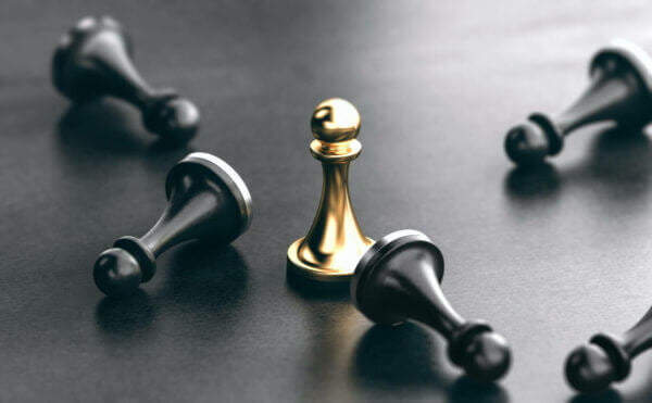 Competitive analysis PPC Marketing Strategy Concept showing a gold chess piece and 4 black chess pieces knocked down.